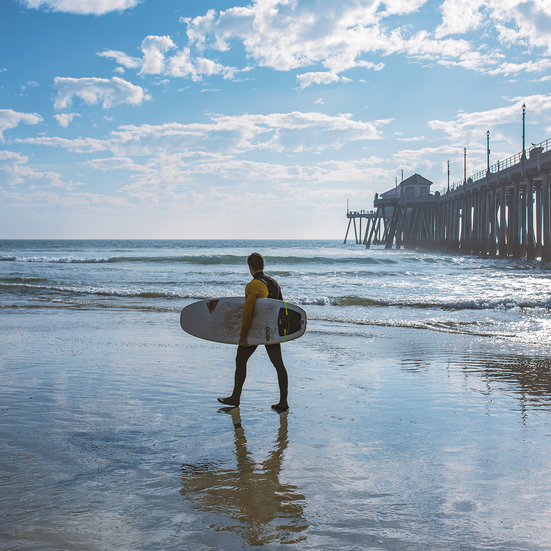 Surfer Heading Out in Huntington Beach, CA